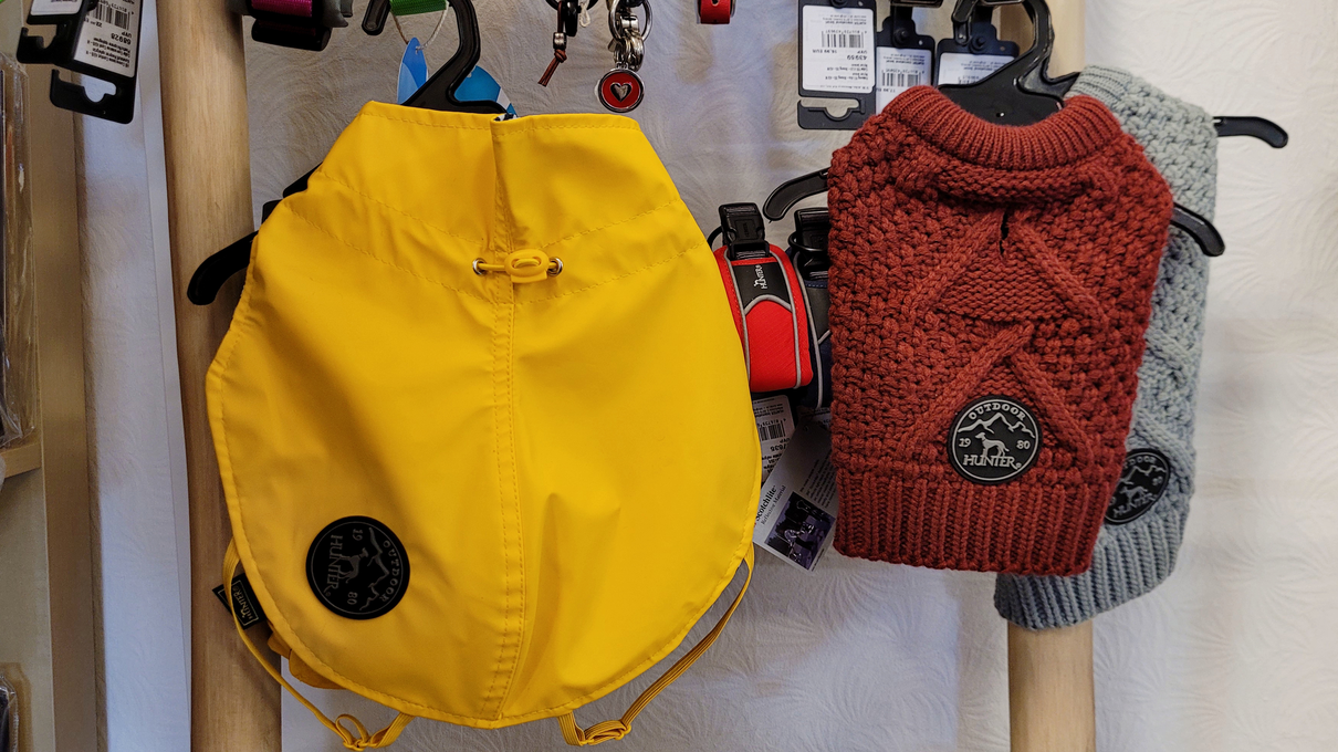 Regenmäntel für Hunde sowie Hundepullover sind auch im Angebot.
